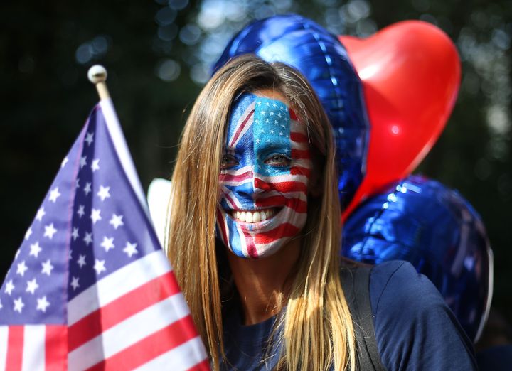 An activist has her face painted with the British and American flags on a 'Stop Trump' campaign bus in London