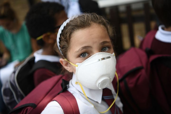 Children at nearby schools wore protective face masks near the burning Grenfell Tower block in West London.