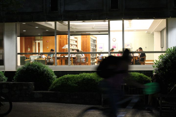 Safe walkers wait outside of the Undergraduate and Davies Libraries for students leaving late at night. Two safe walkers are together at all times during trips, each with their own bike. 