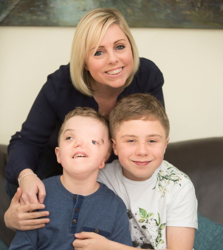 Charlie Beswick and her 12-year-old twin sons Harry (L) and Oliver (R).