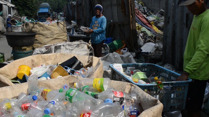 Materials Recovery Facility at Smokey Mountain, Metro Manila. Waste workers busy segregating different materials for recycling. 