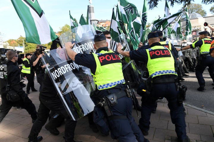Police stop Nordic Resistance Movement members from walking along a forbidden street during their march in Gothenburg, Sweden