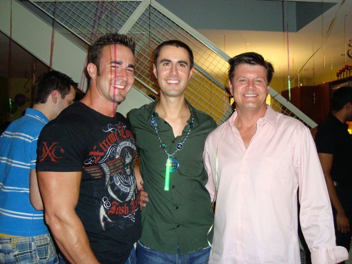 John Grove, left, with his brother Brian, center, and father Bob, right, at a party in 2008.