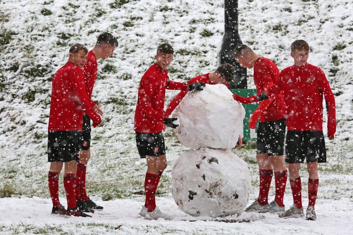 Sunderland academy players build a snowman showing the bad weather that forced an indoor training session at The Academy of Light 