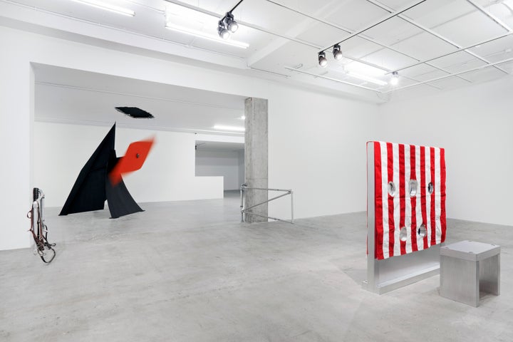 Installation view of Kinetics of Violence: Alexander Calder + Cady Noland, curated by Sandra Antelo-Suarez, Venus Over Manhattan, 2017. Left and right center: Cady Nolan, open view of Corral Gates, 1989, pipes police straps, cattle straps. Collection Fondazione Sandretto Re Rebaudengo, Torino. Left center: Alexander Calder, Rhombus, metal, 1972. Moved by interaction with the blade. Collection of Calder Foundation. Far right: Cady Nolan, rear view of Gibbet (in 2 parts), aluminum, wood and fabric, 153 x 142.9 x 20.3 cm. (60.2 x 56.3 x 8 in.). Private Collection.