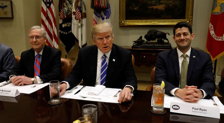 Senate Majority Leader Mitch McConnell (R-Ky.), left, and House Speaker Paul Ryan (R-Wis.), right, sit alongside President Donald Trump. Cutting taxes is a major triumph for the trio.