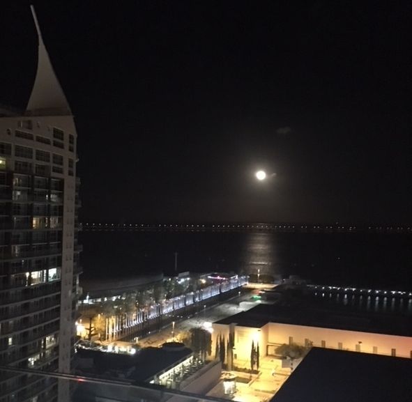  A full moon over the River Tagus, Park of Nations, and Altice Arena in Lisbon.