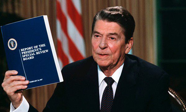 President Ronald Reagan showing a report on the Iran-Contra scandal, February 26, 1987.