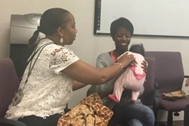 <p>Hannah White, right, with her five-week old daughter Maddilyn, meets with case manager Denise Duckett last month during her postpartum visit in Asheville, North Carolina. White was a patient in a statewide network of pregnancy medical homes that serves expectant mothers in Medicaid. </p>