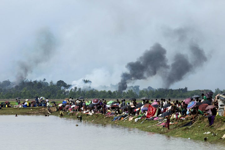 Smoke billows above what is believed to be a burning village in Myanmar's Rakhine state as members of the Rohingya Muslim min