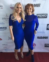 Website AllAboutTheTea.com got an advanced photo of Kim D. (pictured on the left) in the 2017 Posche fashion show.