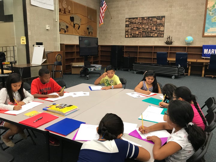 Students from a school in Kennett Square, Pennsylvania, working on a book about immigration and gender equality las