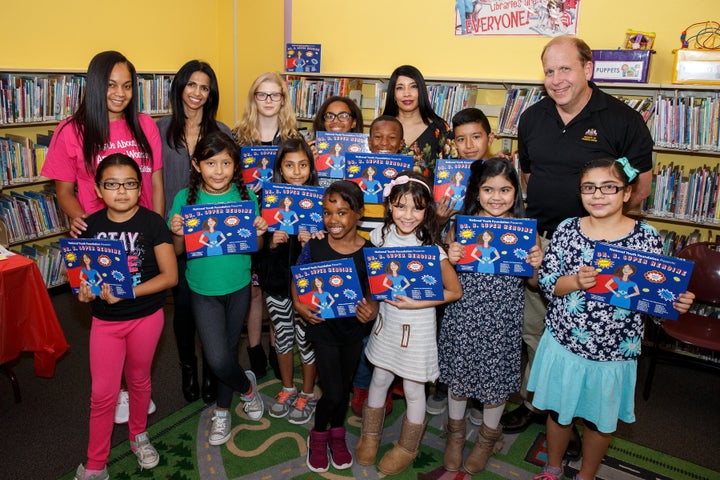 National Youth Foundation co-founder Sophia Hanson (center, back row) with students who participated in a book-writing project earlier this year.