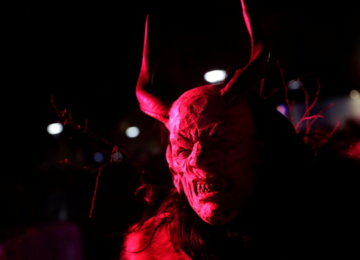 A Krampus show participant shows off his mask in Schladming, Austria, on Nov. 25, 2017