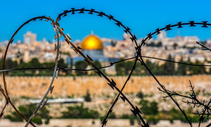 The Dome of the Rock in Jerusalem, as seen through barbed wire.