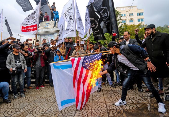 Palestinian protesters burn the US and Israeli flags in Gaza City ahead of Donald Trump's expected decision to recognise Jerusalem as Israel's capital