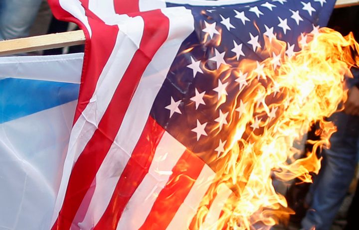A US flag burns during the protests