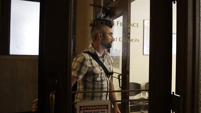 <p>Carrying $40,131.88 in cash in a shoulder bag, Jerred Kiloh, owner of a medical marijuana dispensary, enters a Los Angeles City Hall office to pay his taxes. While the marijuana market remains cash-heavy, it’s getting easier for marijuana businesses to open bank accounts.</p>
