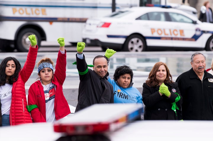 Immigration protesters, including Rep. Luis Gutiérrez (center), stand in a line after being arrested at the U.S. Capitol on Dec. 6.