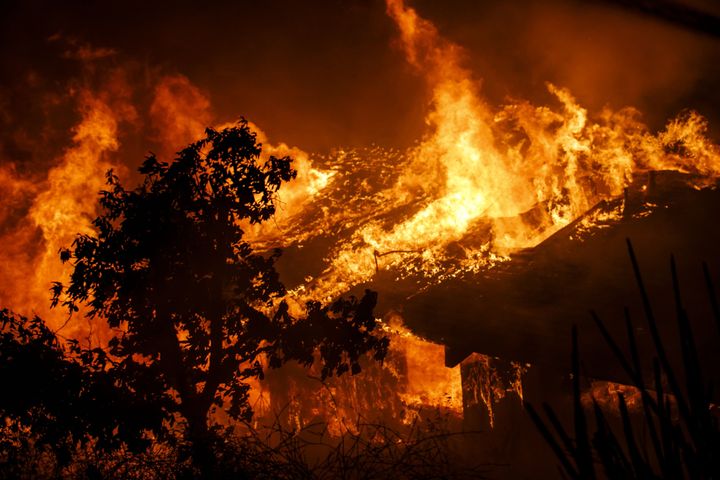 Flames consume a home as a brush fire sweeps through Oak View, a community in Ventura County, on Tuesday.
