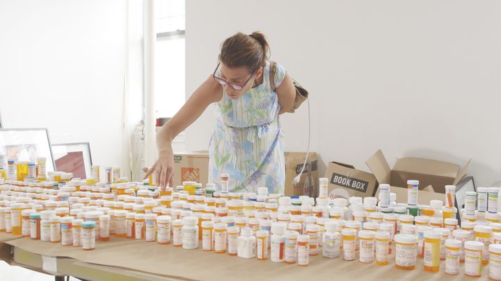 <p>Hope with some of the medication bottles Ruth had saved.</p>