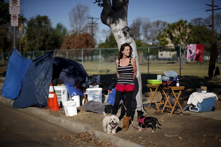 Stacie McDonough, 51, is an army veteran with a college degree who was made made homeless. In this Oct. 2015 picture, she's seen posing by her tent near LAX airport in Los Angeles, California.