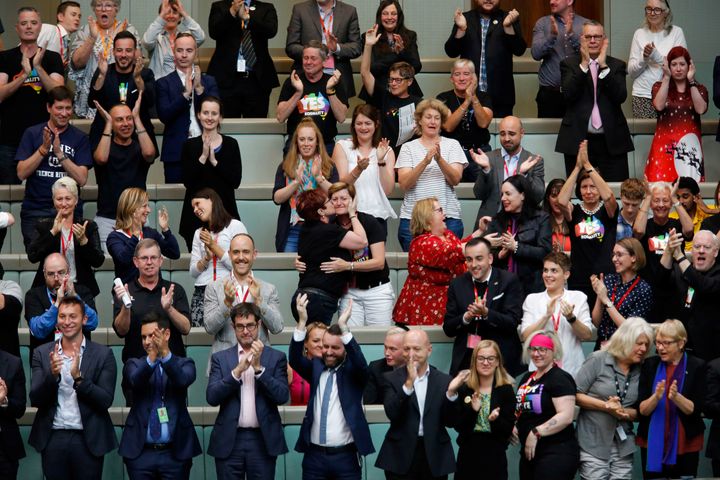 Members of the public applaud after the Australian Parliament passed the same-sex marriage bill in the Federal Parliament in Canberra on December 7, 2017 