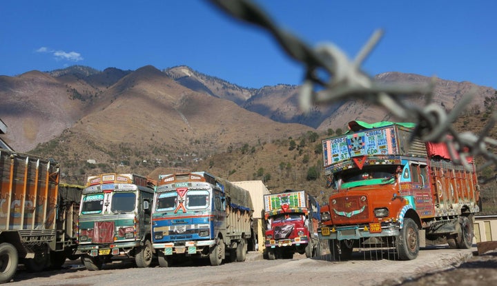 Trading trucks wait to cross the Line of Control in Chakothi, Pakistan-administered Kashmir