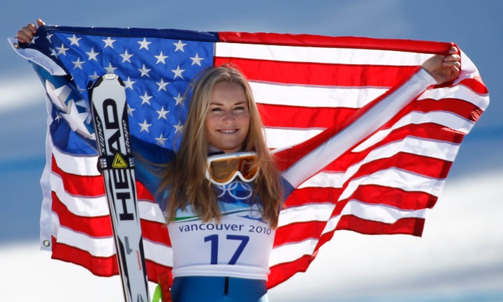 Vonn holds up a flag after winning bronze at the 2010 Winter Olympics. 