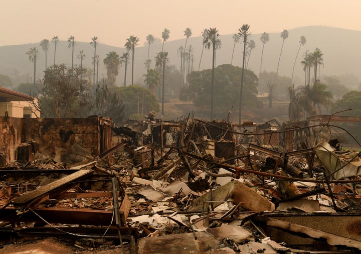 Trees are seen through the haze at the burn-out Vista del Mar Hospital after the Thomas wildfire swept through Ventura on Wed
