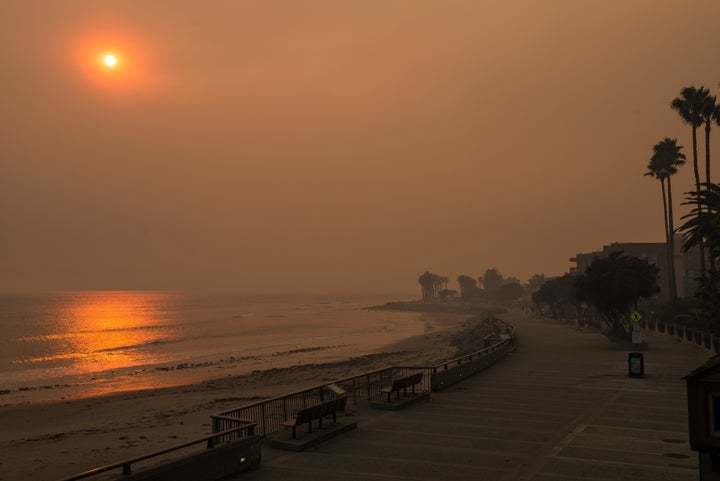 The beach next to the Ventura Pier is seen surrounded by smoke on Wednesday.