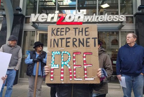 People protest the FCC's proposed net neutrality repeal outside a Verizon store on Dec. 7, 2017.