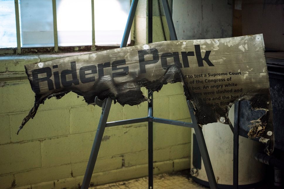 A sign, burned by arsonists, which was used to mark the proposed site of Freedom Riders Park, is now housed in the Freedom Ri