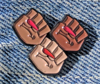 <p>GRL TRBL’s Solidarity Fist pin.</p>
