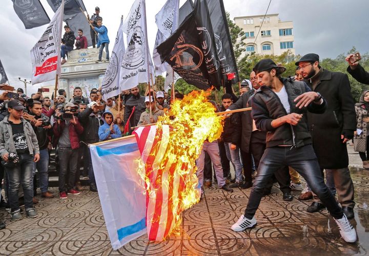 Mission accomplished? Palestinian protesters burn American and Israeli flags in Gaza City after President Donald Trump declares that Jerusalem belongs to Israel.