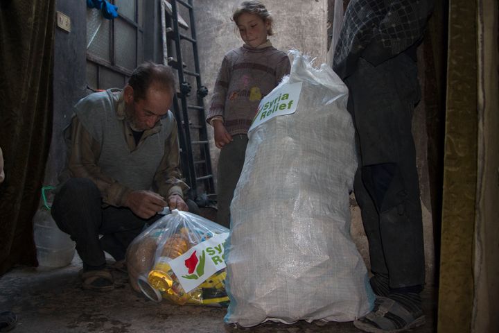 A family in Eastern Ghouta receiving a food parcel
