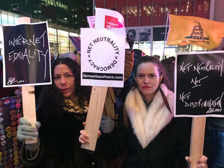 Net neutrality supporters Jennifer Elster (right) and friend gather at a rally in front of a Verizon store on 42nd Street in New York City on Dec. 7.