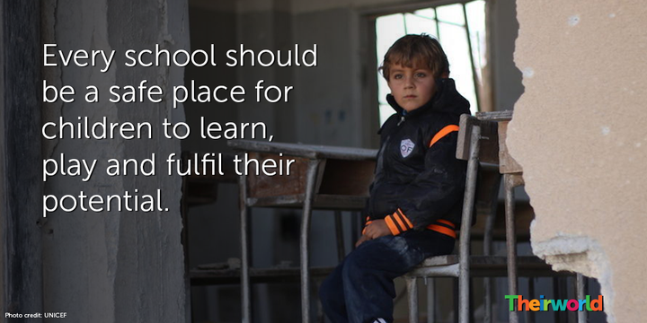 Ahmed, 6, sits in his damaged school, in Idlib, north Syria.