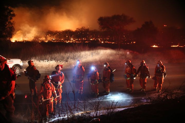 Firefighters walk to the fire line at the Lilac Fire in Bonsall on Dec. 7, 2017.
