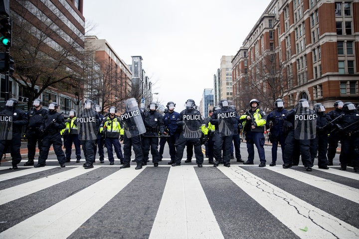 Police officers in riot gear stand lined up during a demonstration in Washington, D.C., after January's inauguration.