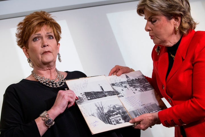 Attorney Gloria Allred (right) and Beverly Young Nelson hold up Nelson's high school yearbook at a press conference in November.