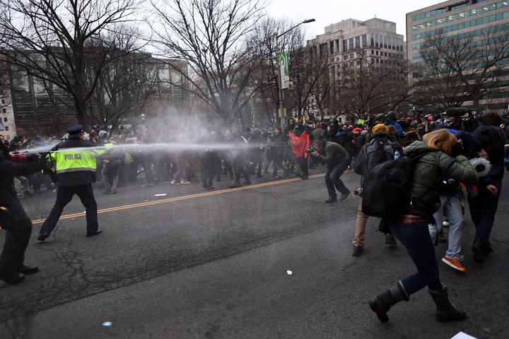 Police pepper spray at anti-Trump protesters during clashes in Washington, D.C. on Jan. 20, 2017.