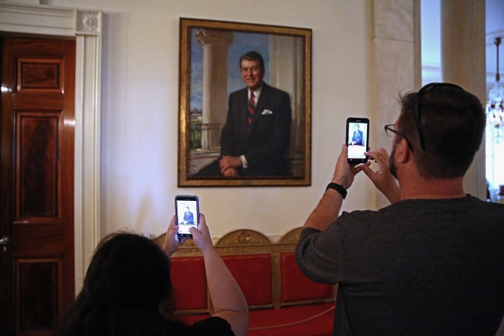 Visitors photograph former President Ronald Reagan's portrait during a tour of the White House. July 1, 2015.