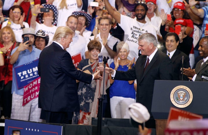 Franklin Graham (right) is greeted by President Donald Trump during an August 2017 rally in Phoenix, Arizona.