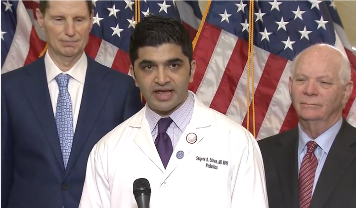 Dec 7, 2017: Sanjeev K Sriram, MD, MPH (aka Dr America), between Senator Ron Wyden and Senator Ben Cardin, speaking about the Republican tax bills’ devastating impact on health care. 