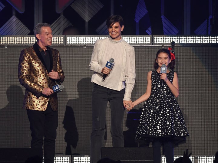 Radio host Elvis Duran, Katie Holmes and Suri Cruise onstage at Z100's iHeartRadio Jingle Ball 2017 on Dec. 8, 2017.