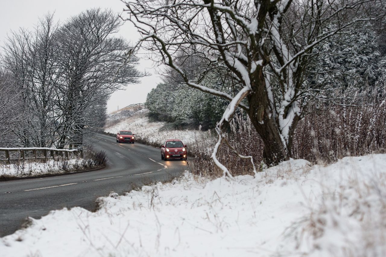 Cars travel on a cleared road near Diggle, Greater Manchester, on Sunday