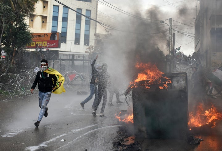 Demonstrators burn garbage container during a protest against U.S. President Donald Trump's announcement to recognize Jerusal