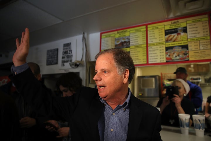 Democratic Senate candidate Doug Jones waves to reporters as he leaves a restaurant in Birmingham, Alabama, Dec. 11, 2017.