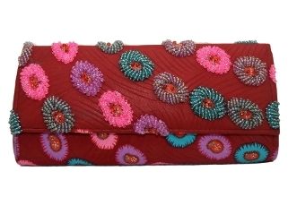 A timeless piece, this clutch features intricate details such as hand-sewn beads. 